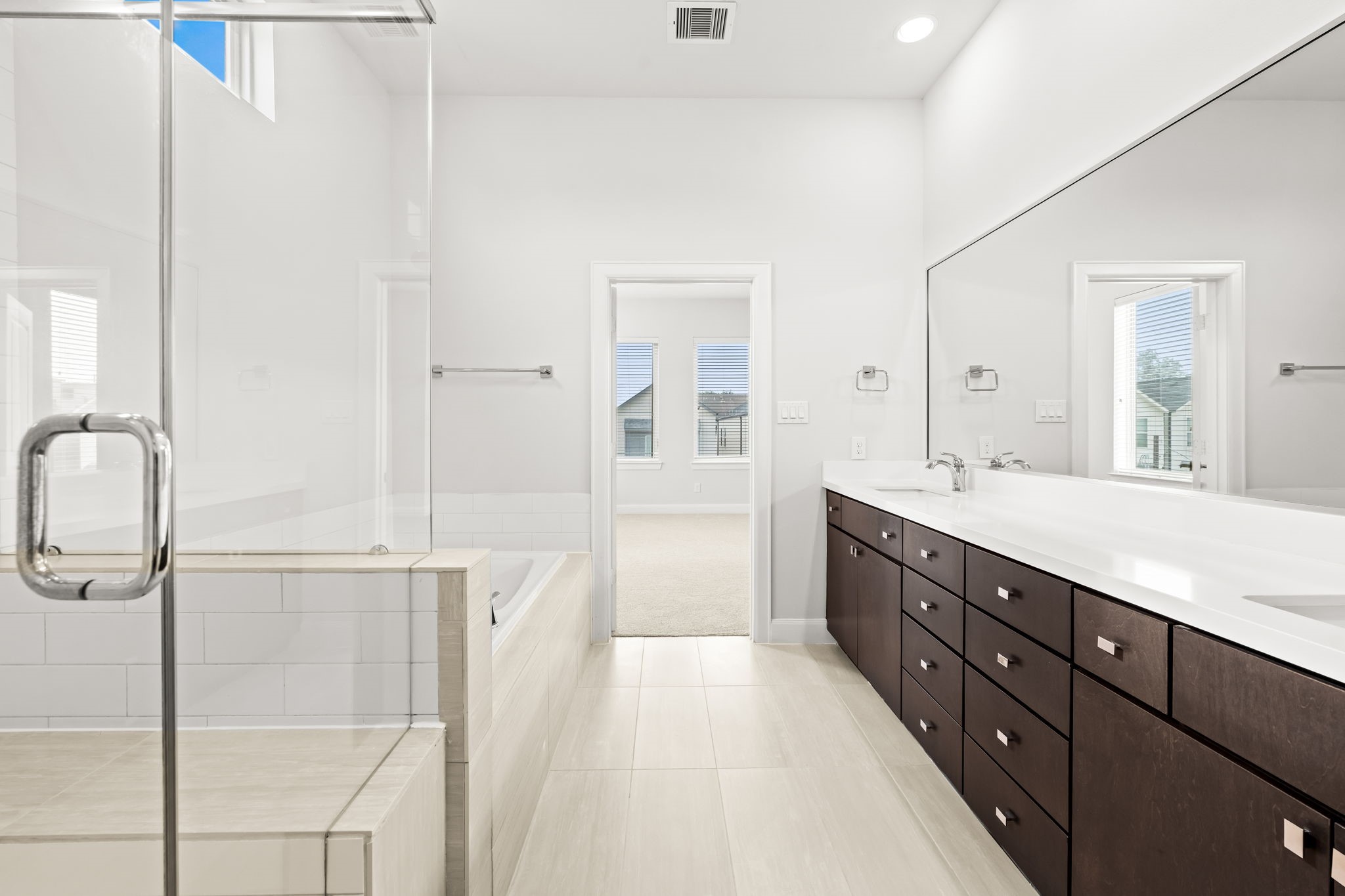 4115 Schuler Street Houston, TX 77007 - Photo 24 of 32 Light filled primary bath with an extended double vanity, sleek finishes and a spacious walk in shower.