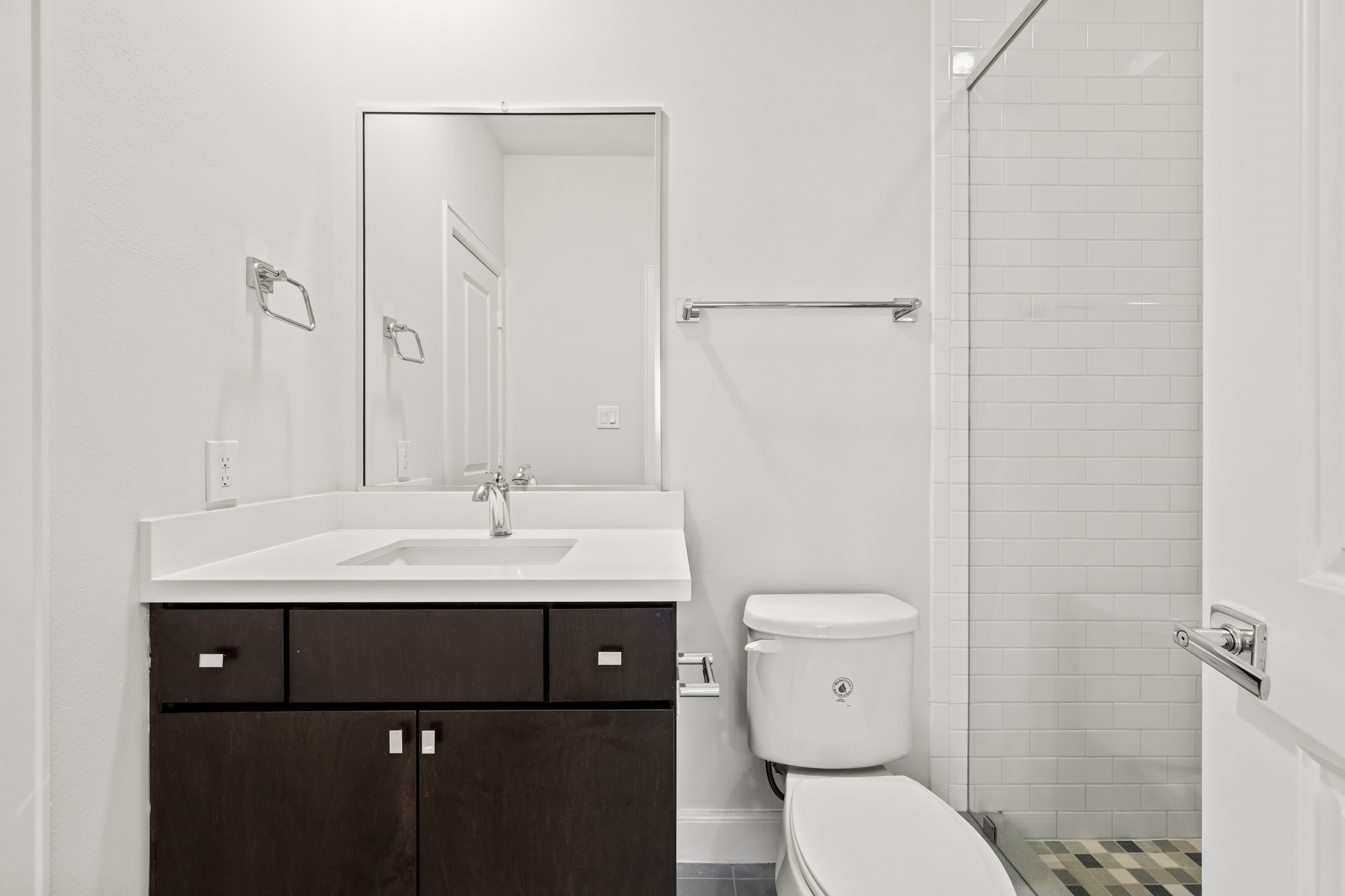 4115 Schuler Street Houston, TX 77007 - Photo 6 of 32 Clean and modern full bath featuring a sleek vanity, neutral finishes, and a glass enclosed shower.