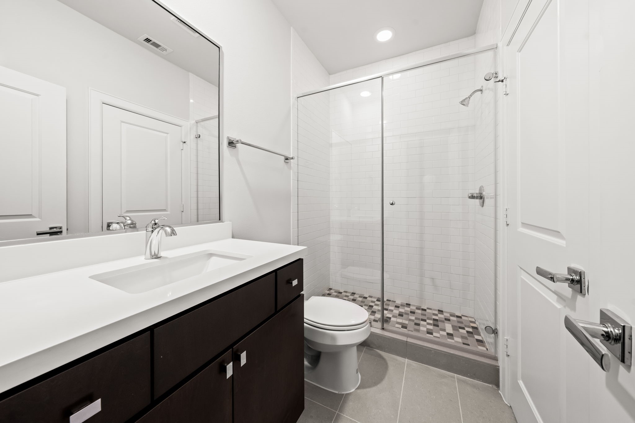 4115 Schuler Street Houston, TX 77007 - Photo 7 of 32 Sleek vanity with abundant storage and counter space with an oversized glass shower.