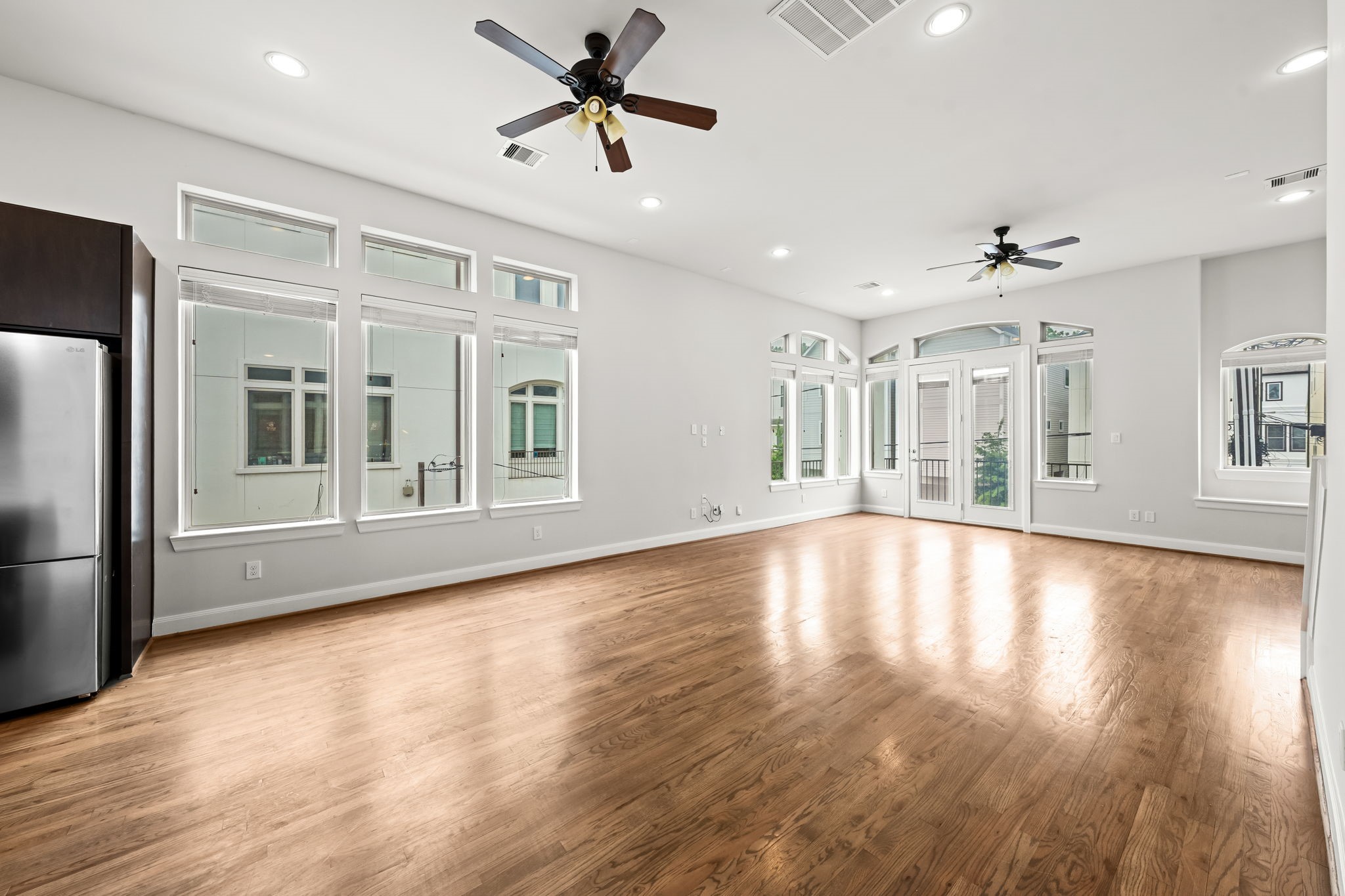 4115 Schuler Street Houston, TX 77007 - Photo 8 of 32 Expansive open living space with hardwood floors, soaring ceilings and walls of windows bringing in incredible natural light.