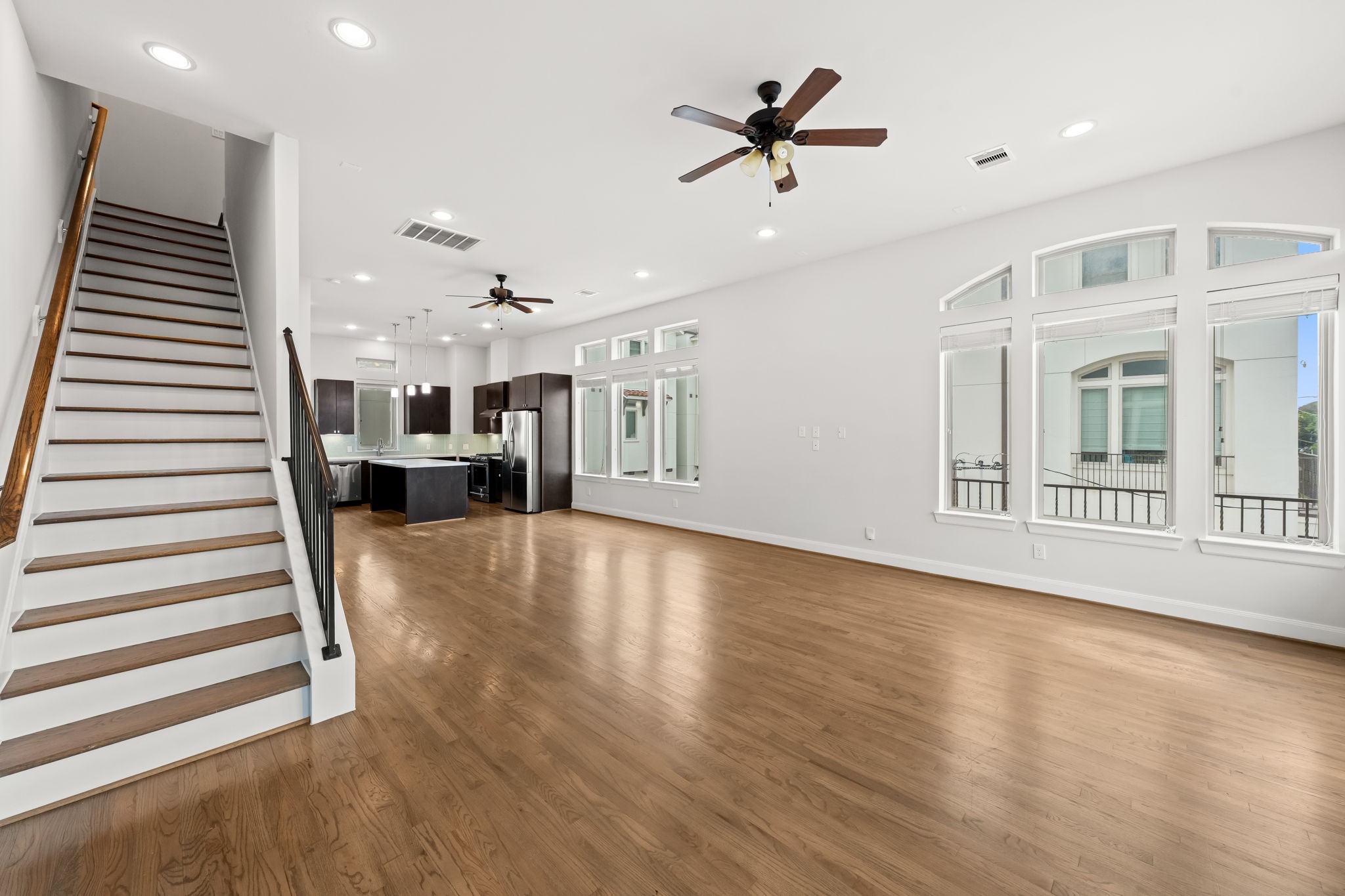 4115 Schuler Street Houston, TX 77007 - Photo 10 of 32 Bright open living and dining space with hardwood floors, oversized windows and seamless flow into the kitchen.