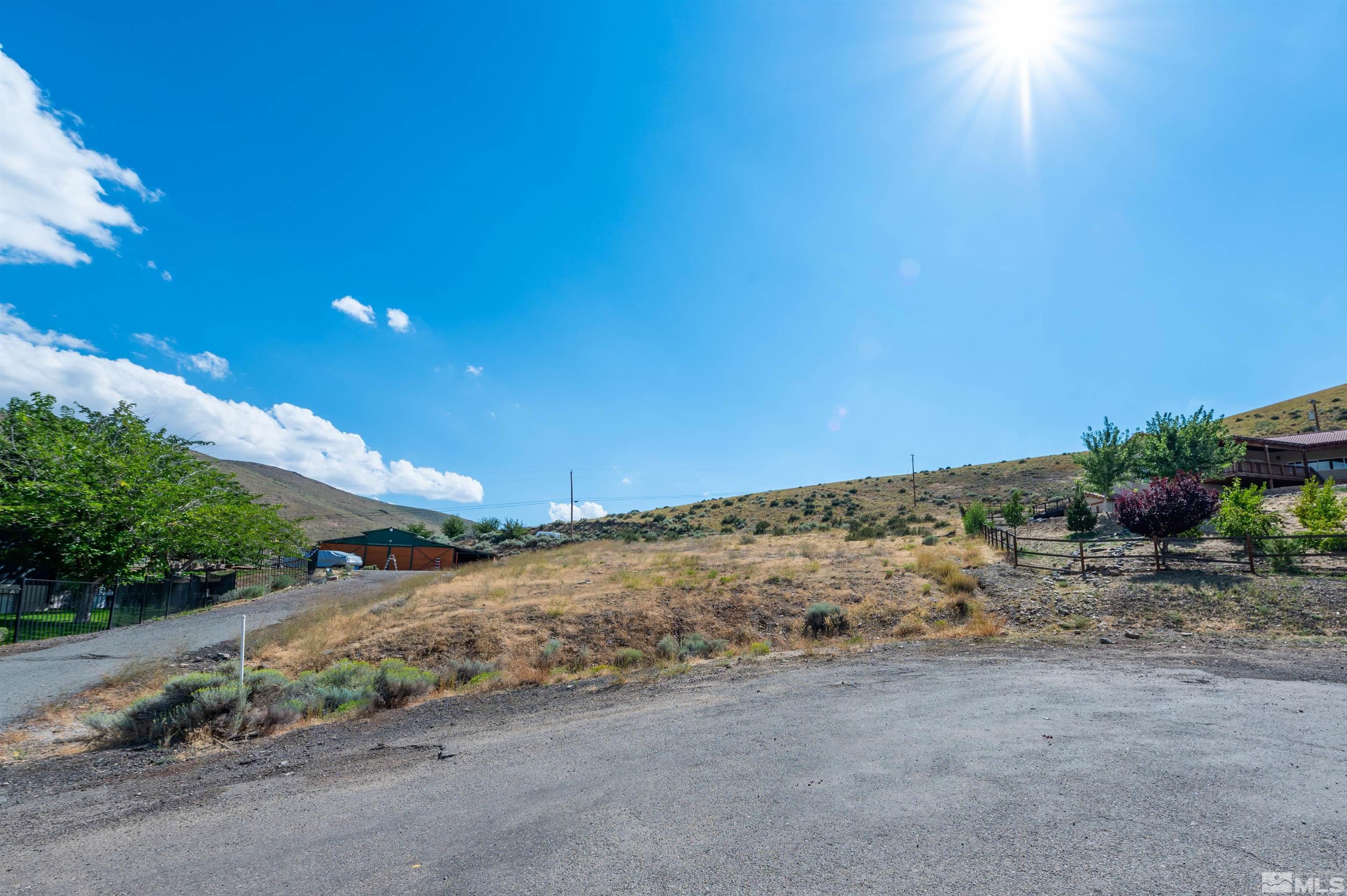 110 Del Mesa Circle Reno, NV 89521 - Photo 2 of 33 a view of a road with a building in the background