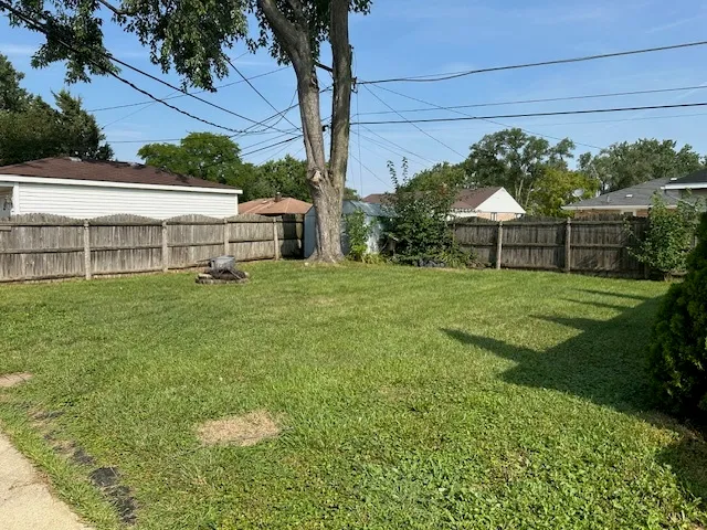 a view of a house with a yard and sitting area