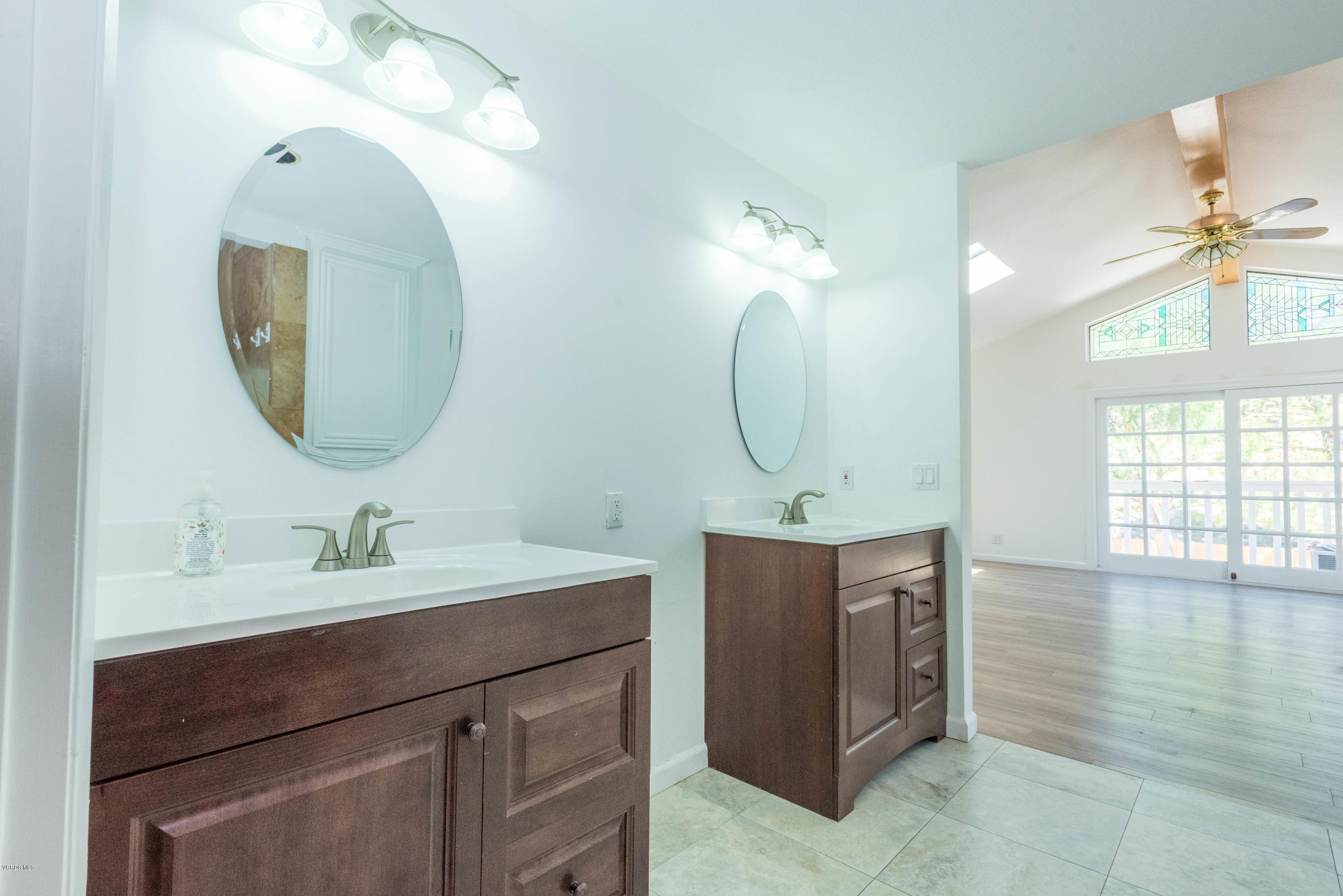 26026 Redbluff Drive Calabasas, CA 91302 - Photo 18 of 23 a en suite bathroom with a double vanity sink and a mirror