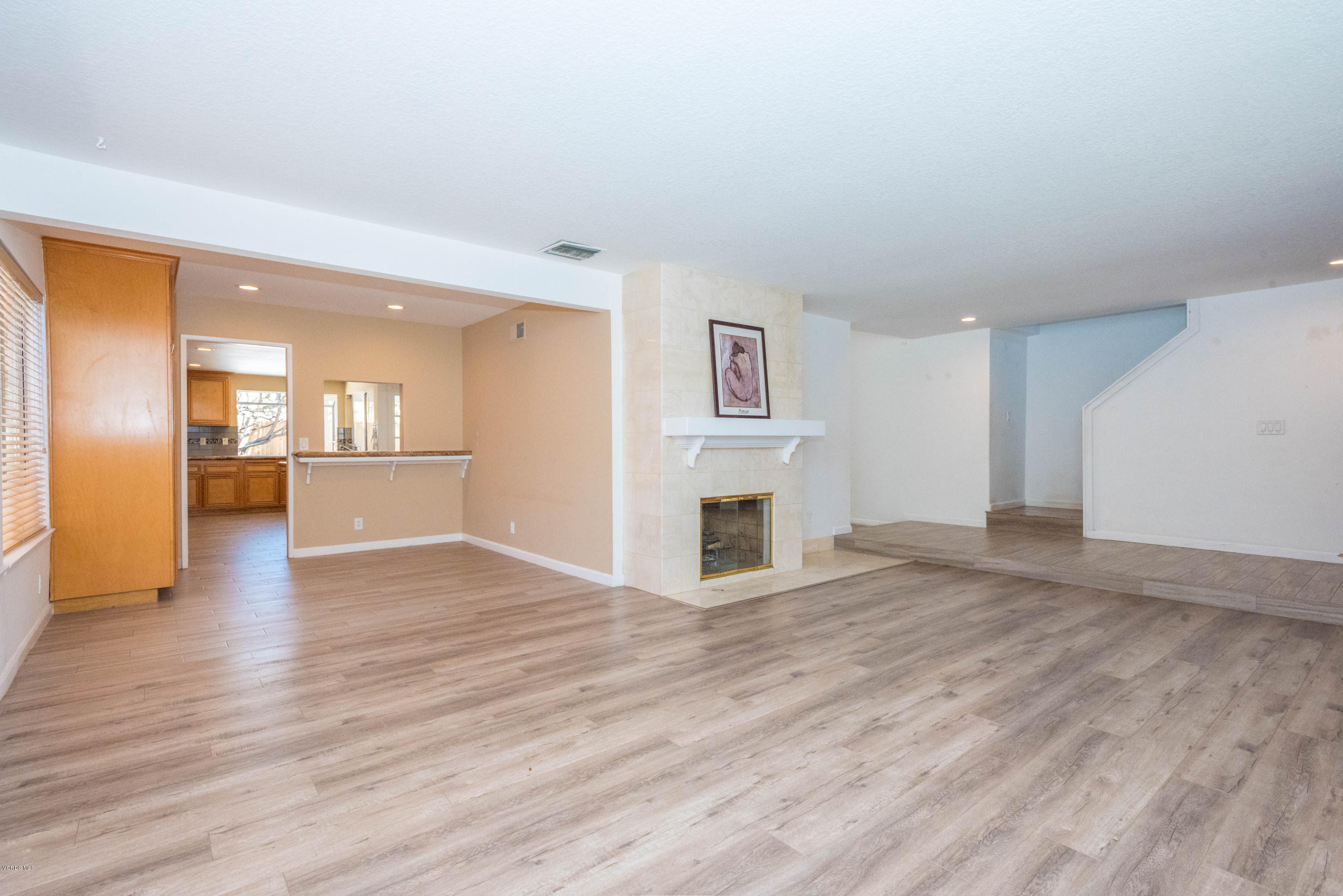 26026 Redbluff Drive Calabasas, CA 91302 - Photo 5 of 23 a view of a livingroom with wooden floor and a kitchen space