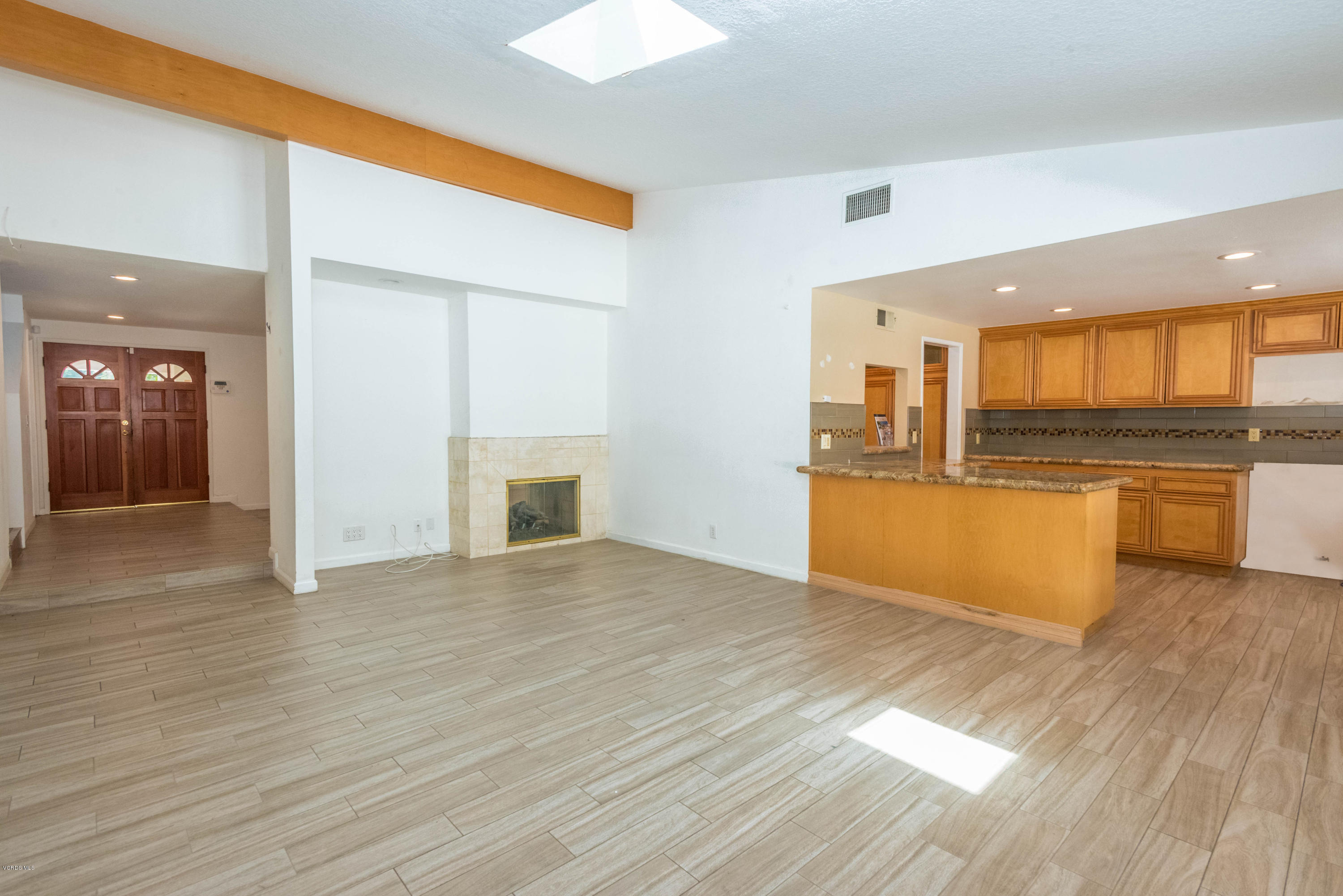 26026 Redbluff Drive Calabasas, CA 91302 - Photo 10 of 23 a view of a kitchen with a sink a microwave and cabinets