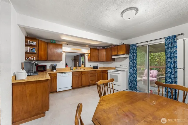 a kitchen with stainless steel appliances granite countertop a stove sink and cabinets