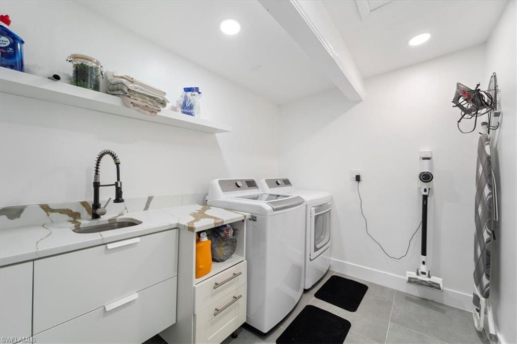 2123 Holiday Lane Naples, FL 34104 - Photo 19 of 32 Laundry area featuring sink, cabinets, and independent washer and dryer
