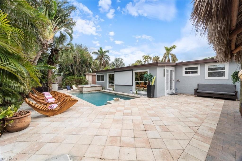 2123 Holiday Lane Naples, FL 34104 - Photo 21 of 32 View of swimming pool featuring a jacuzzi, french doors, and a patio