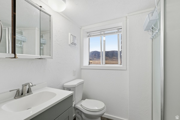 25615 Main Street Portage, UT 84331 - Photo 21 of 42 Bathroom with a textured wall, vanity, and a mountain view