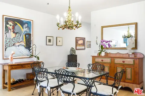 a view of a dining room with furniture and a chandelier