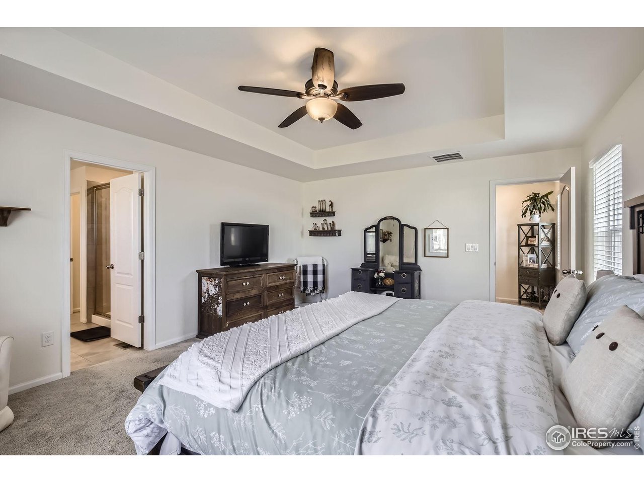 12889 Clearview Street Firestone, CO 80504 - Photo 12 of 38 a bedroom with a bed and a flat tv screen
