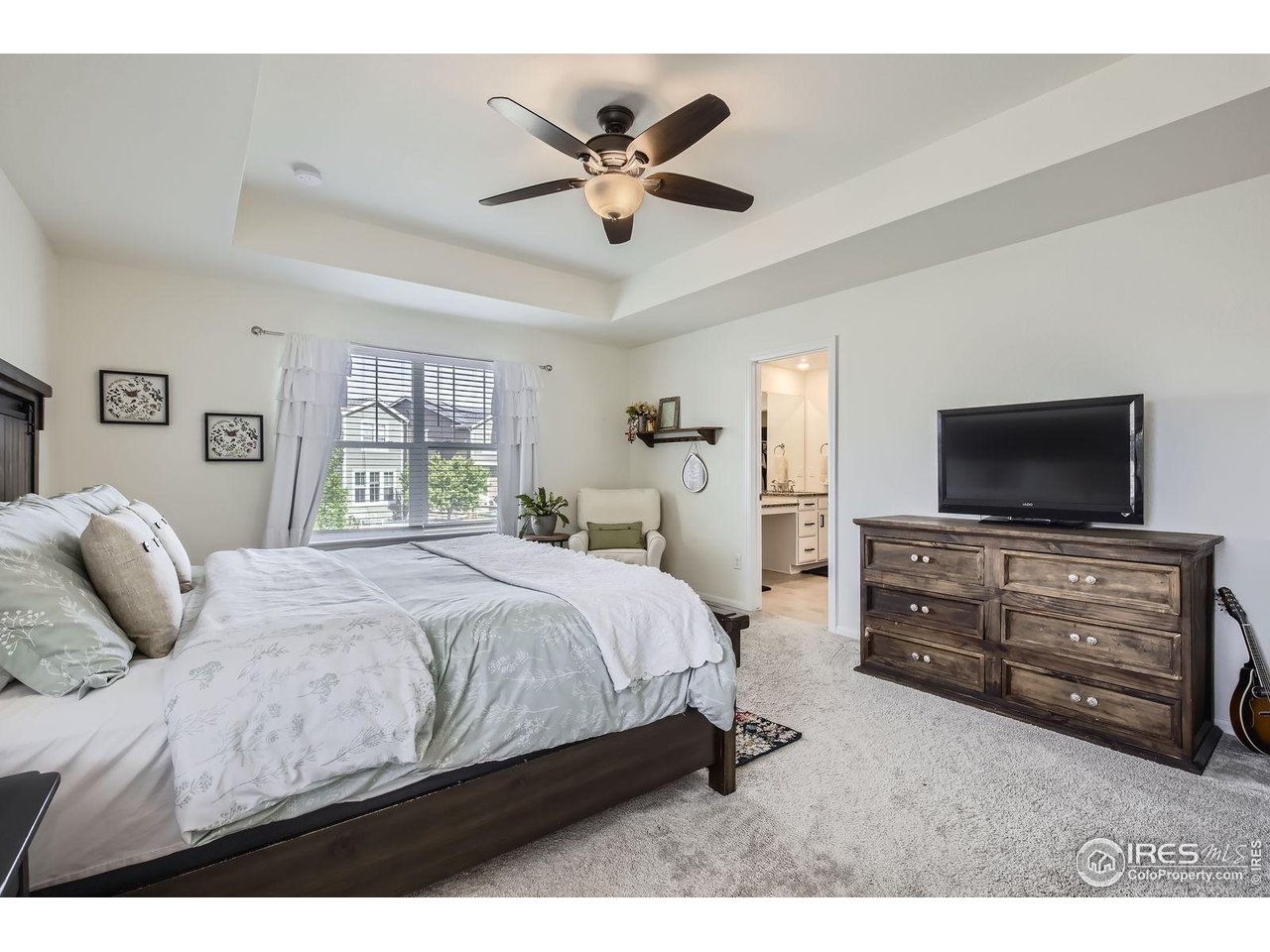 12889 Clearview Street Firestone, CO 80504 - Photo 13 of 38 a bedroom with a bed and a flat screen tv