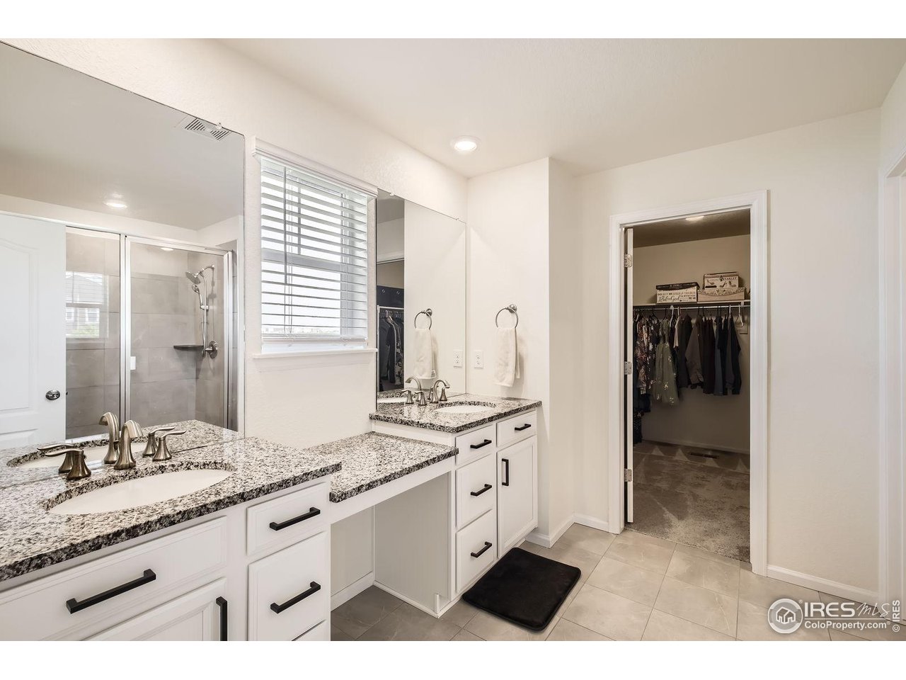12889 Clearview Street Firestone, CO 80504 - Photo 14 of 38 a bathroom with a sink a vanity and a mirror