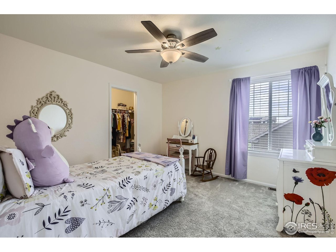 12889 Clearview Street Firestone, CO 80504 - Photo 16 of 38 a bedroom with a bed and a chandelier