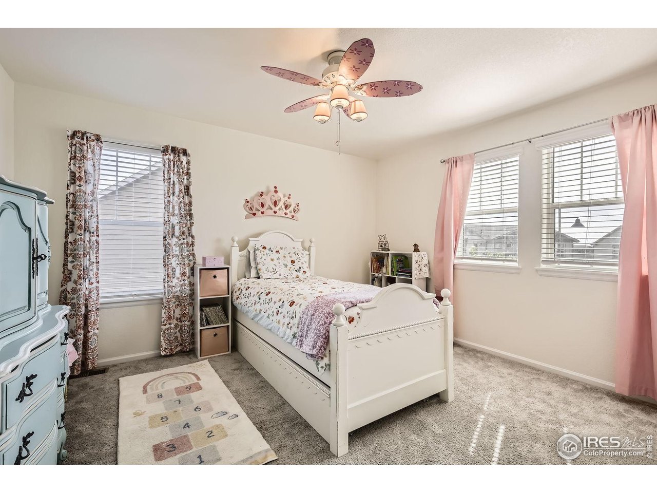 12889 Clearview Street Firestone, CO 80504 - Photo 18 of 38 a bed sitting in a bedroom next to a window