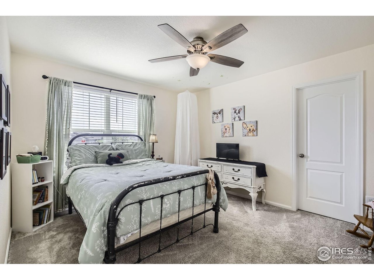 12889 Clearview Street Firestone, CO 80504 - Photo 19 of 38 a bedroom with a bed and a chandelier