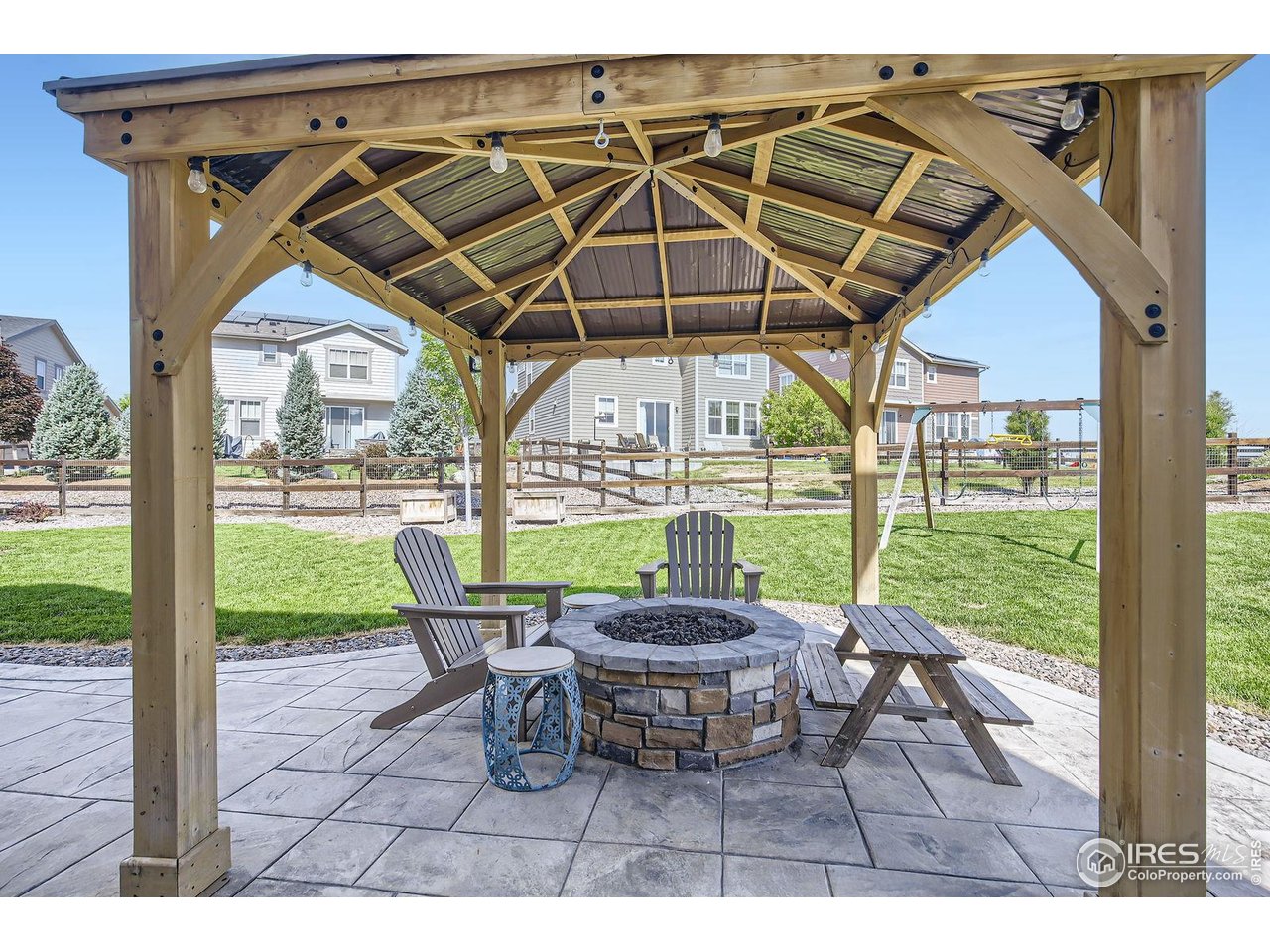 12889 Clearview Street Firestone, CO 80504 - Photo 24 of 38 a patio with glass top table and chairs