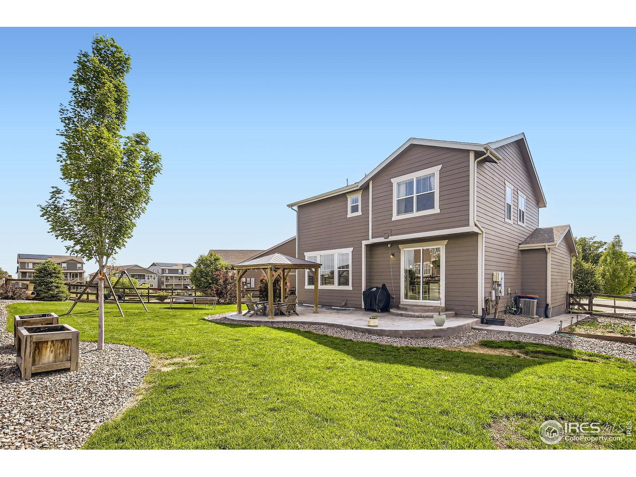 12889 Clearview Street Firestone, CO 80504 - Photo 26 of 38 a house view with swimming pool and bench