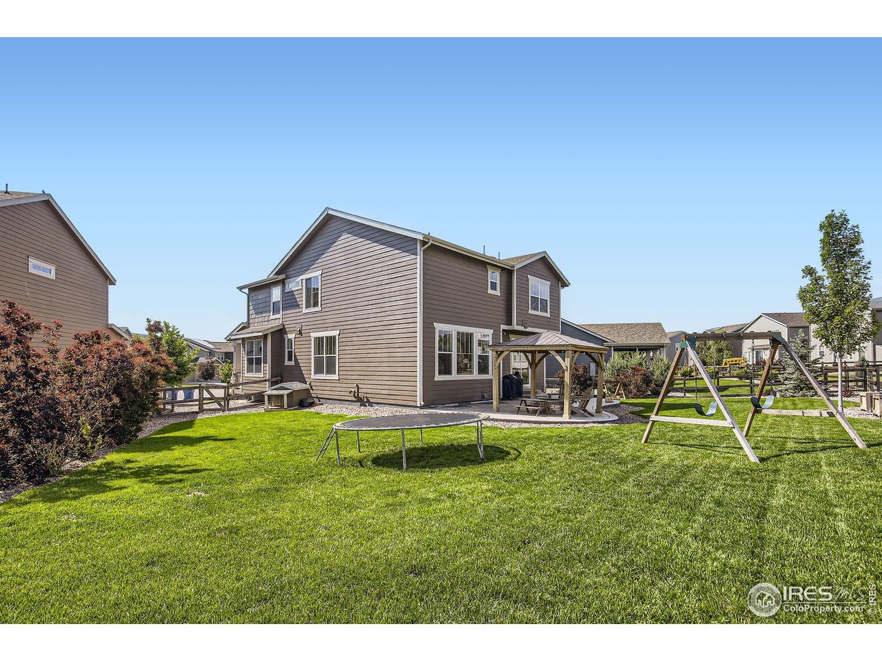 12889 Clearview Street Firestone, CO 80504 - Photo 27 of 38 a backyard of a house with table and chairs