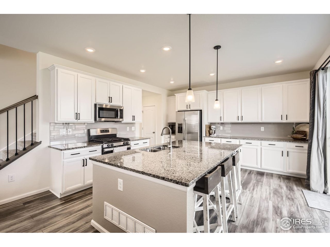 12889 Clearview Street Firestone, CO 80504 - Photo 5 of 38 a kitchen with stainless steel appliances granite countertop a stove refrigerator sink and cabinets