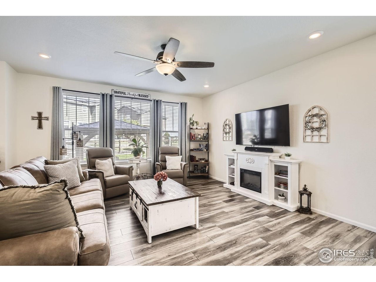 12889 Clearview Street Firestone, CO 80504 - Photo 8 of 38 a living room with furniture and a flat screen tv