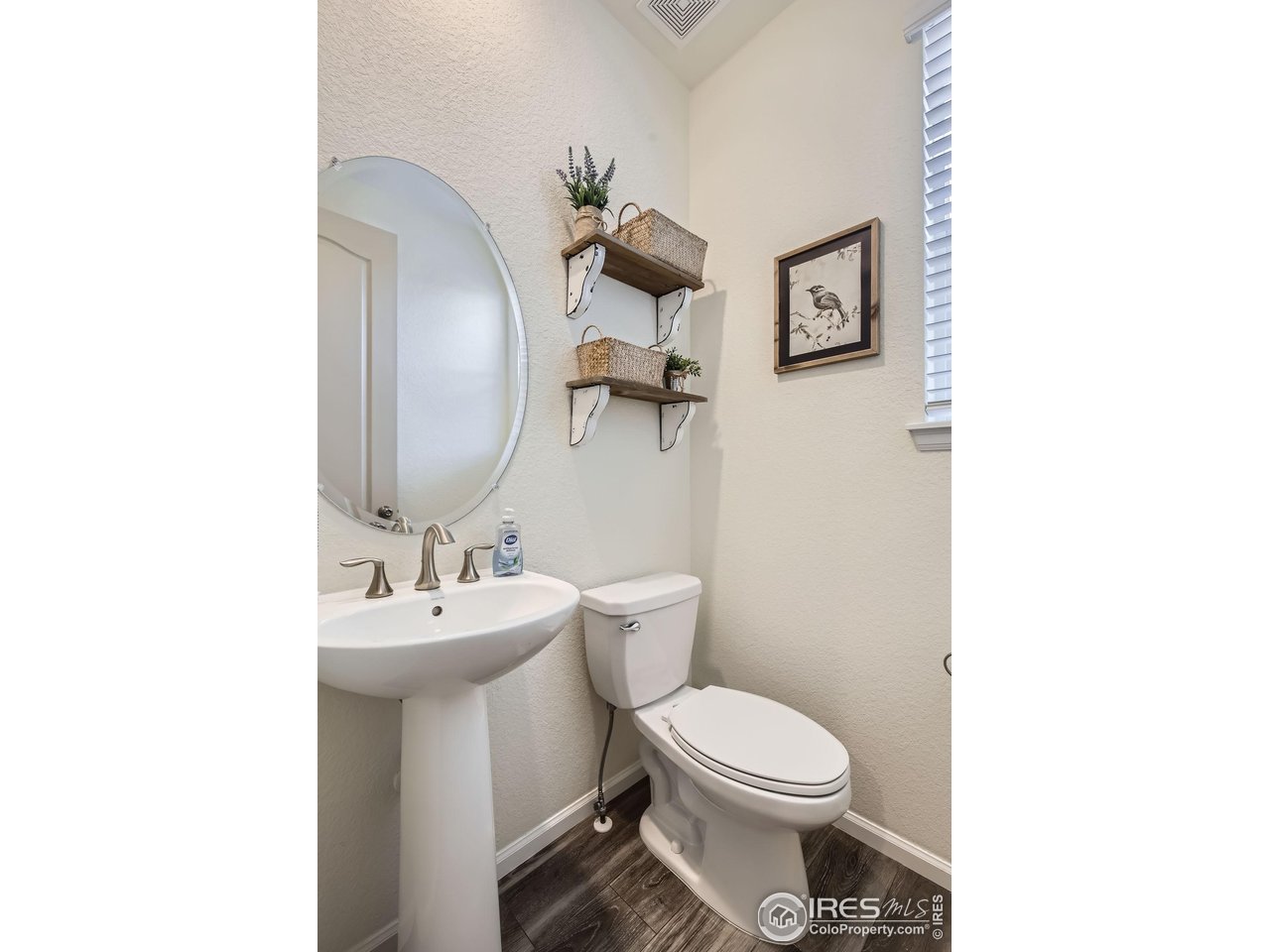 12889 Clearview Street Firestone, CO 80504 - Photo 10 of 38 a bathroom with a toilet sink and mirror