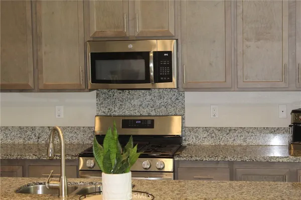 a stove top oven sitting inside of a kitchen