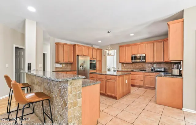 a front view of a house with a yard and trees