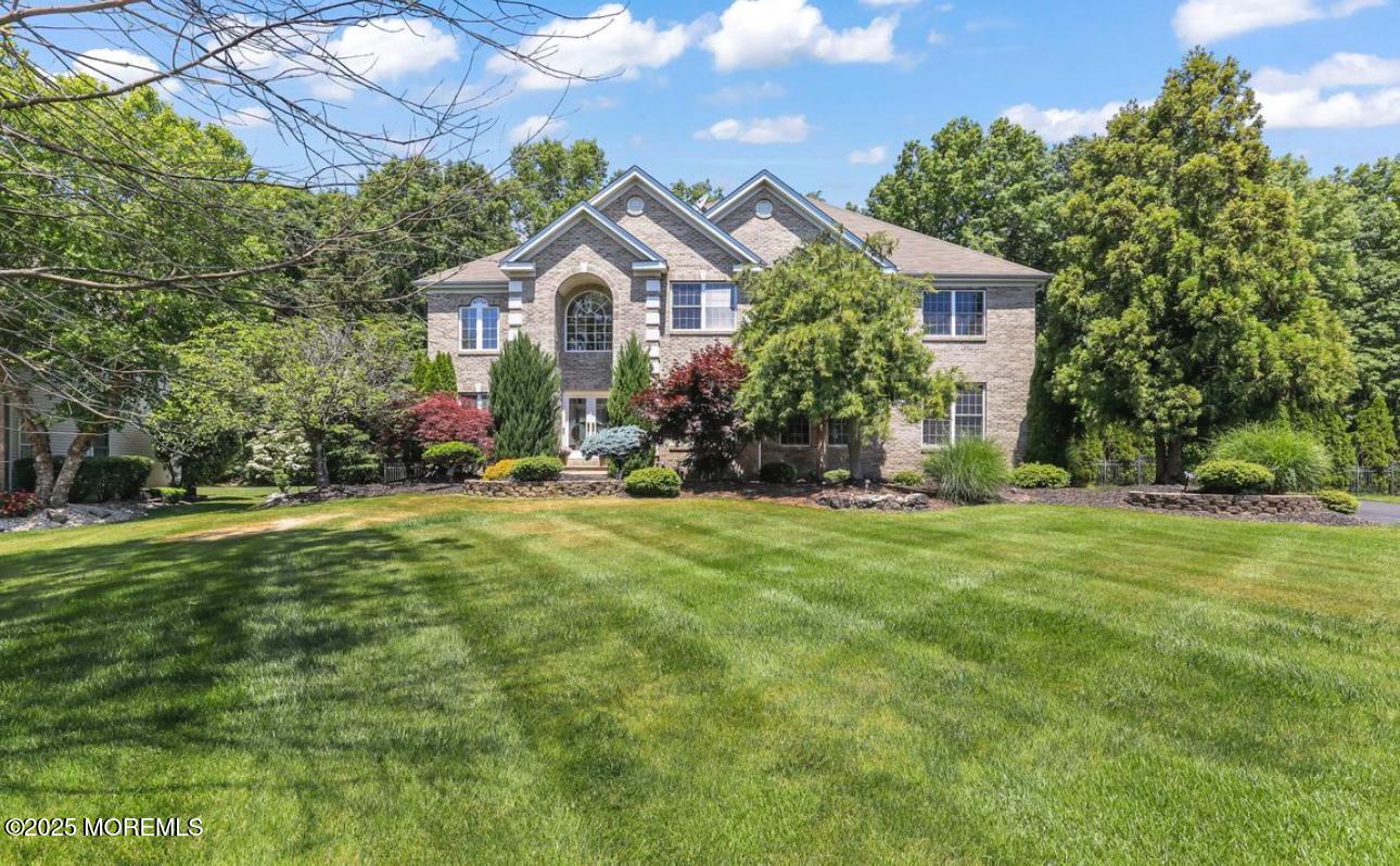 7 Round Hill Road Jackson, NJ 08527 - Photo 12 of 55 a front view of a house with a yard and trees