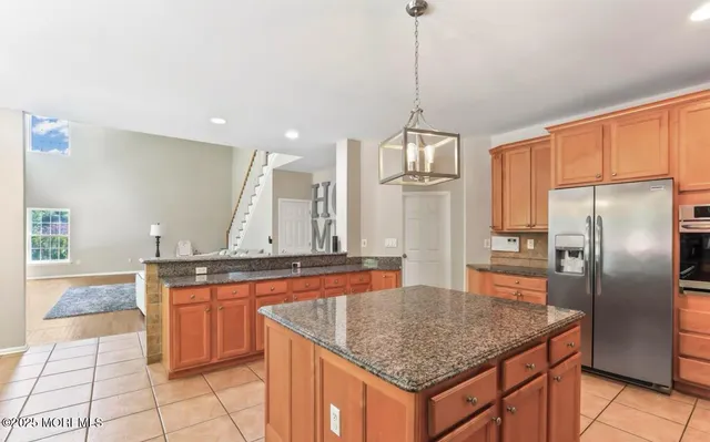 a view of a dining room with furniture a chandelier and wooden floor