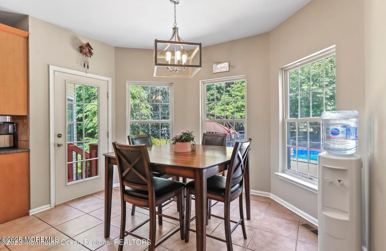 7 Round Hill Road Jackson, NJ 08527 - Photo 15 of 55 a view of a dining room with furniture a chandelier and wooden floor