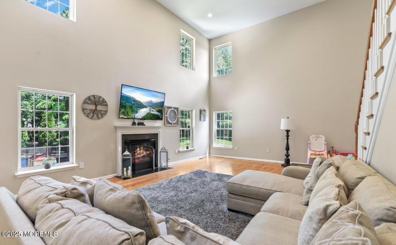 7 Round Hill Road Jackson, NJ 08527 - Photo 16 of 55 a living room with furniture a fireplace and a flat screen tv