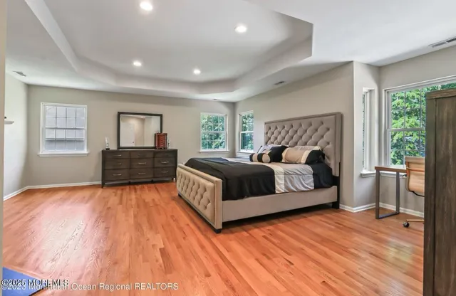 a spacious bedroom with a bed and a fireplace