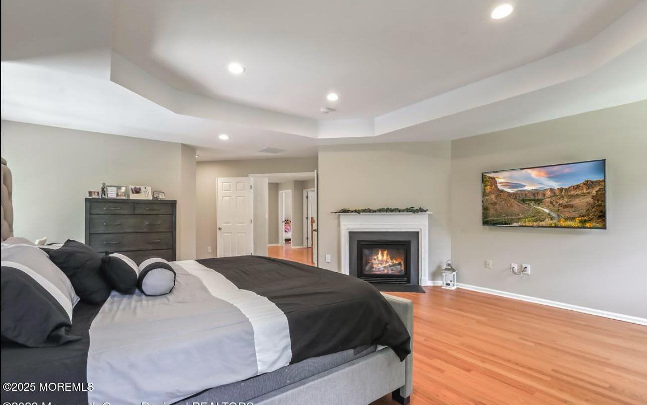 7 Round Hill Road Jackson, NJ 08527 - Photo 23 of 55 a spacious bedroom with a bed and a fireplace