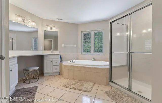 a bathroom with a granite countertop sink mirror bathtub and toilet