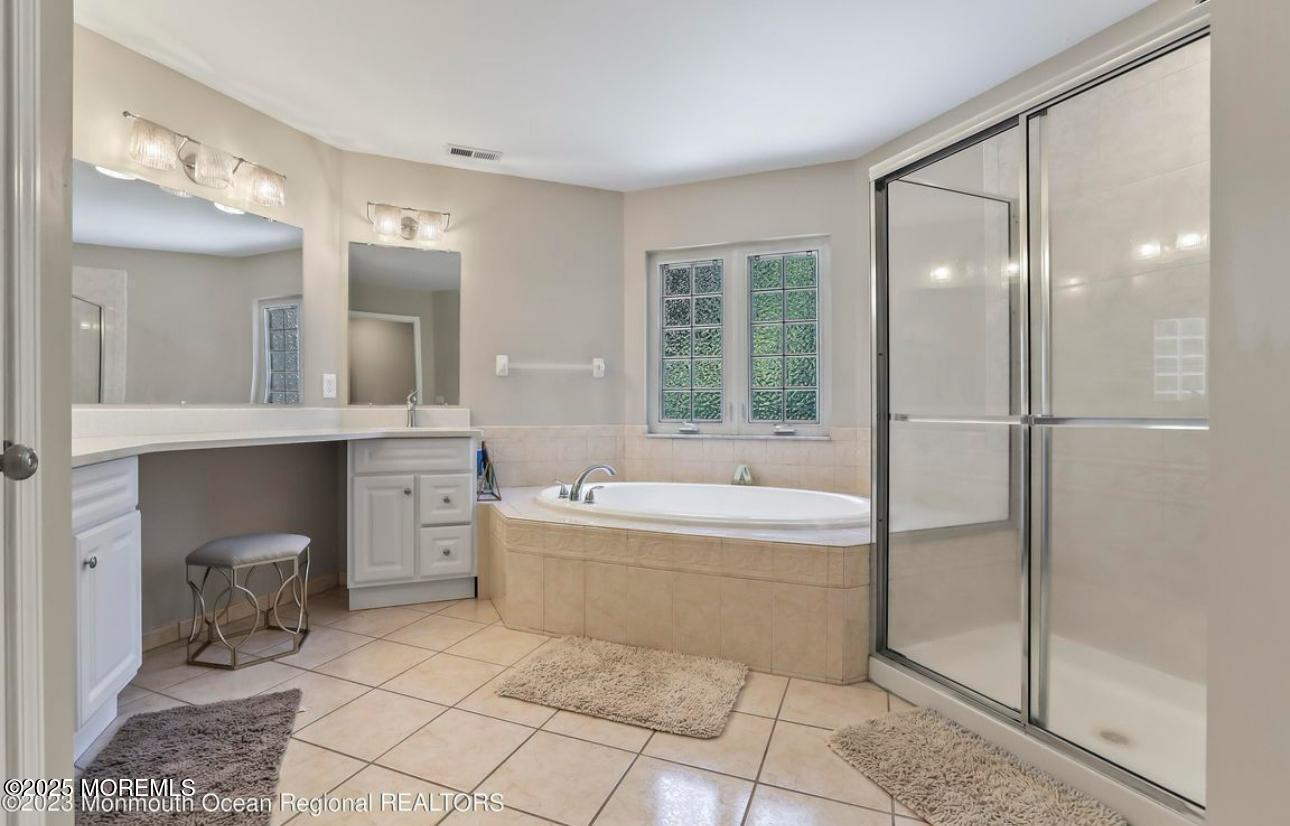 7 Round Hill Road Jackson, NJ 08527 - Photo 24 of 55 a spacious bathroom with a tub sink and mirror