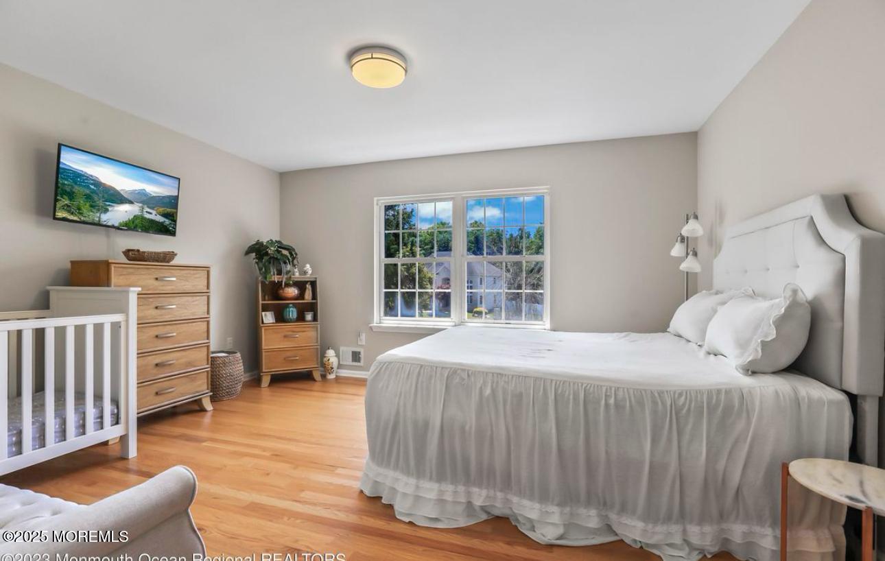 7 Round Hill Road Jackson, NJ 08527 - Photo 28 of 55 a bedroom with a bed and wooden floor