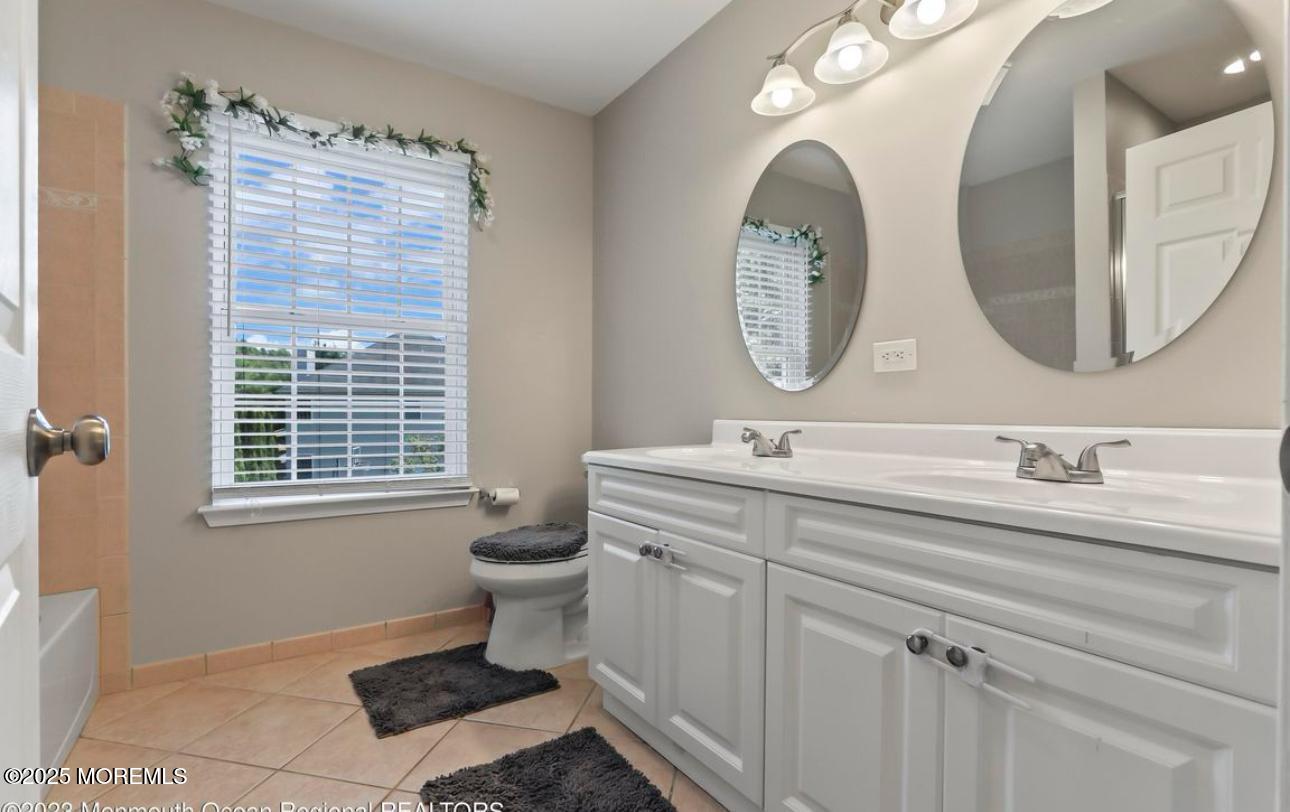 7 Round Hill Road Jackson, NJ 08527 - Photo 29 of 55 a bathroom with a toilet a sink and a mirror