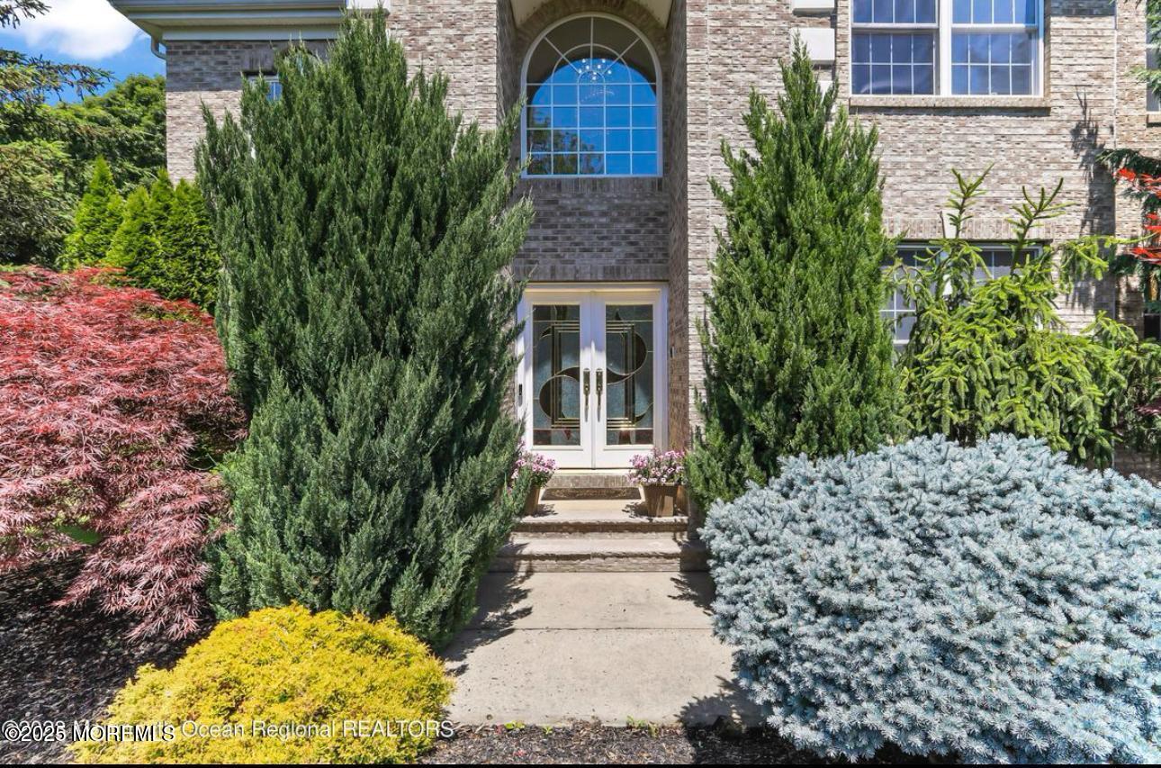 7 Round Hill Road Jackson, NJ 08527 - Photo 3 of 55 a front view of a house with a yard and fountain