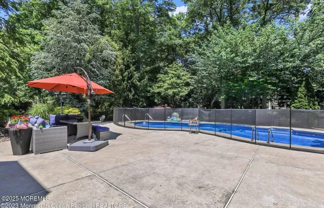 a view of yard with swimming pool and green space