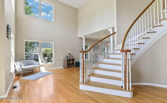 a view of entryway and hall with wooden floor