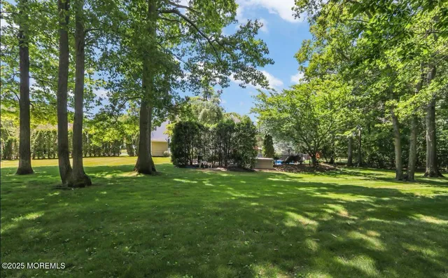 an aerial view of a house with a yard and lake view