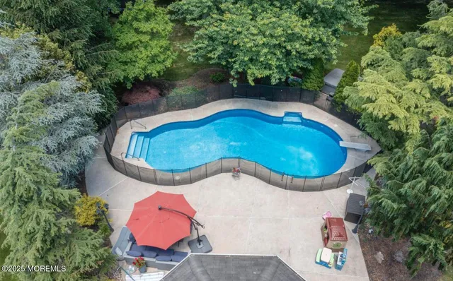 an aerial view of a house with a yard and garden