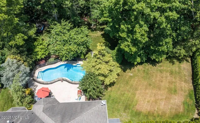 an aerial view of a house with a yard and lake view