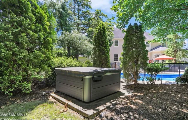 an aerial view of residential house with outdoor space and swimming pool