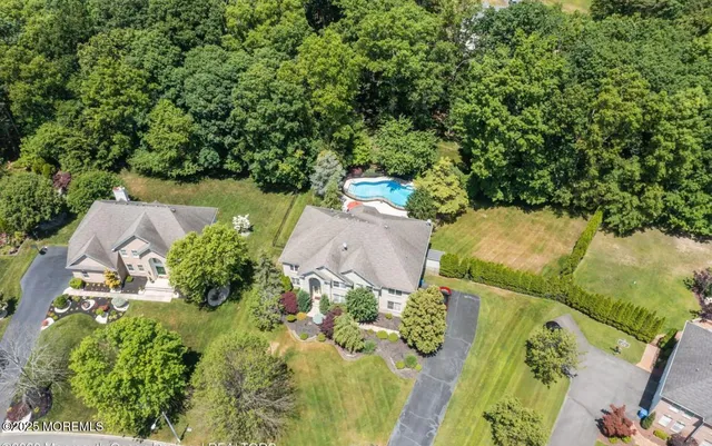 an aerial view of a house with yard swimming pool and outdoor seating