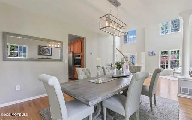 a view of a dining room with furniture window and wooden floor