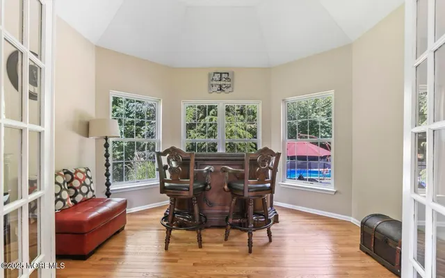 a large kitchen with kitchen island granite countertop a large counter top space a sink a stove and appliances