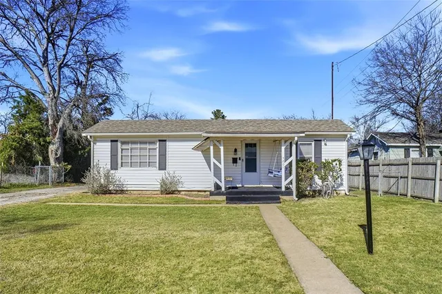 a front view of house with yard and green space